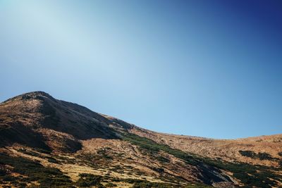 Scenic view of mountains against clear blue sky