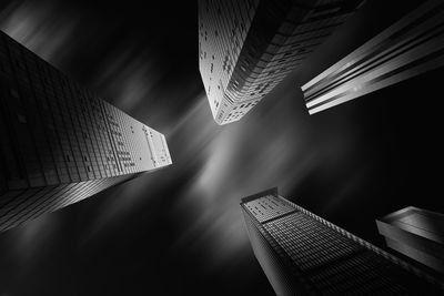 Low angle view of modern buildings against sky at night