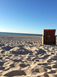 Scenic view of beach against clear blue sky