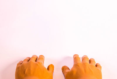 Low section of woman resting against white background