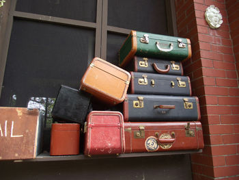 Stack of old fashion luggage on window