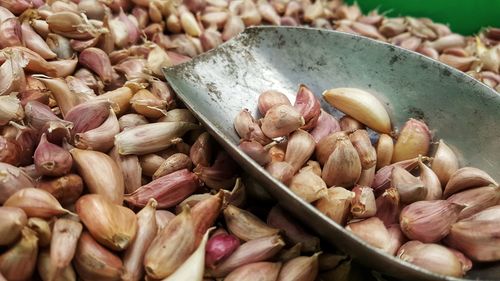 Close-up of garlic cloves and scoop