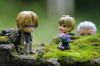 Close-up of boy with toy on grass