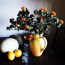 Close-up of fruits in vase on table