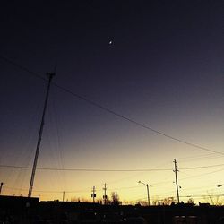 Low angle view of electricity pylon against sky