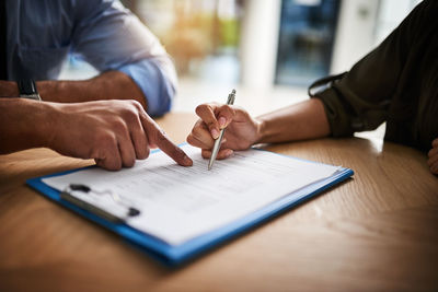 Midsection of businessman working on table