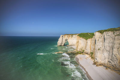 Scenic view of sea against clear blue sky