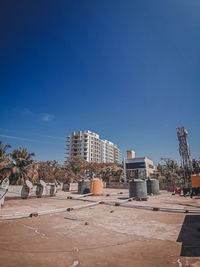 Buildings against clear blue sky