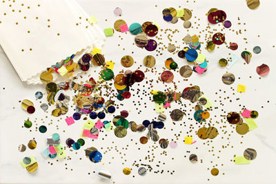 High angle view of colorful confetti on table