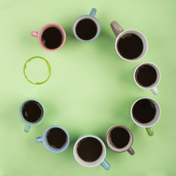 High angle view of coffee and cups on table