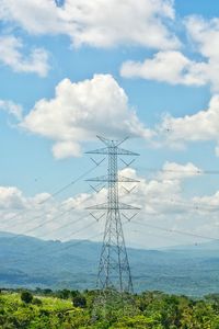 Low angle view of electricity pylon against sky