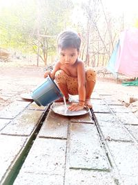 Portrait of cute girl sitting outdoors