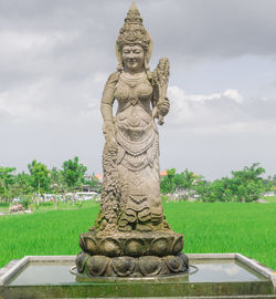 Statue of buddha against sky