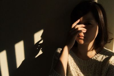 Portrait of upset girl at home in darkroom