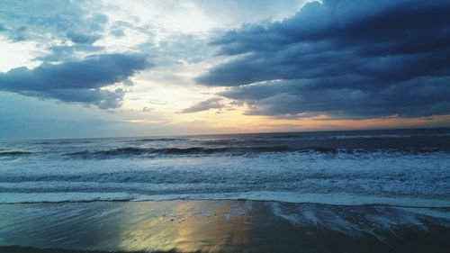 Scenic view of sea against cloudy sky