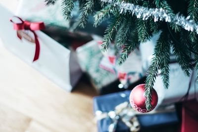 Close-up of christmas tree by presents on table