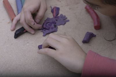 Close-up of woman holding purple hand