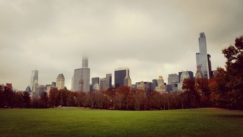 City skyline against cloudy sky