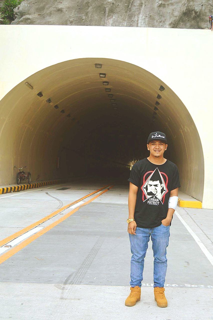 full length, standing, front view, arch, casual clothing, tunnel, casual, primary age child, day, person, looking at camera, the way forward, in front of, innocence, footpath, archway