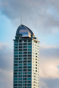 Low angle view of building against cloudy sky