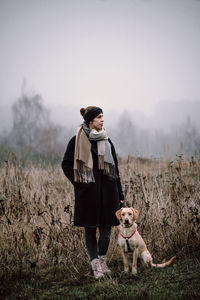 Full length of a dog standing on field during winter