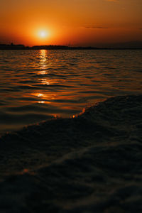 Scenic view of sea against romantic sky at sunset