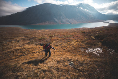 Man standing on mountain against sky