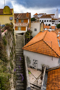 High angle view of houses in town against sky