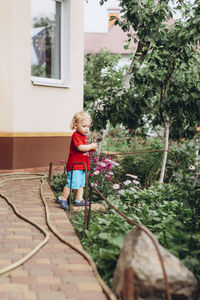 Side view of boy sitting on rock