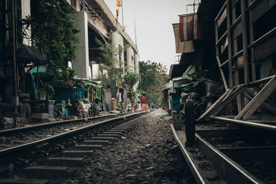 Railroad tracks amidst buildings in city