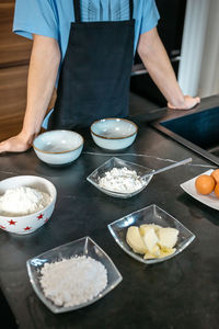 Midsection of man preparing food on table