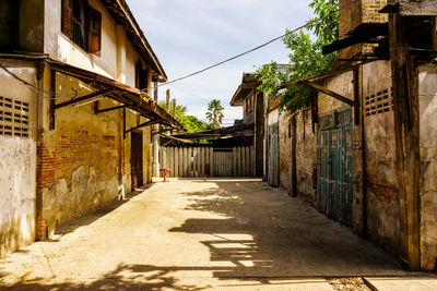 Empty alley amidst houses in town