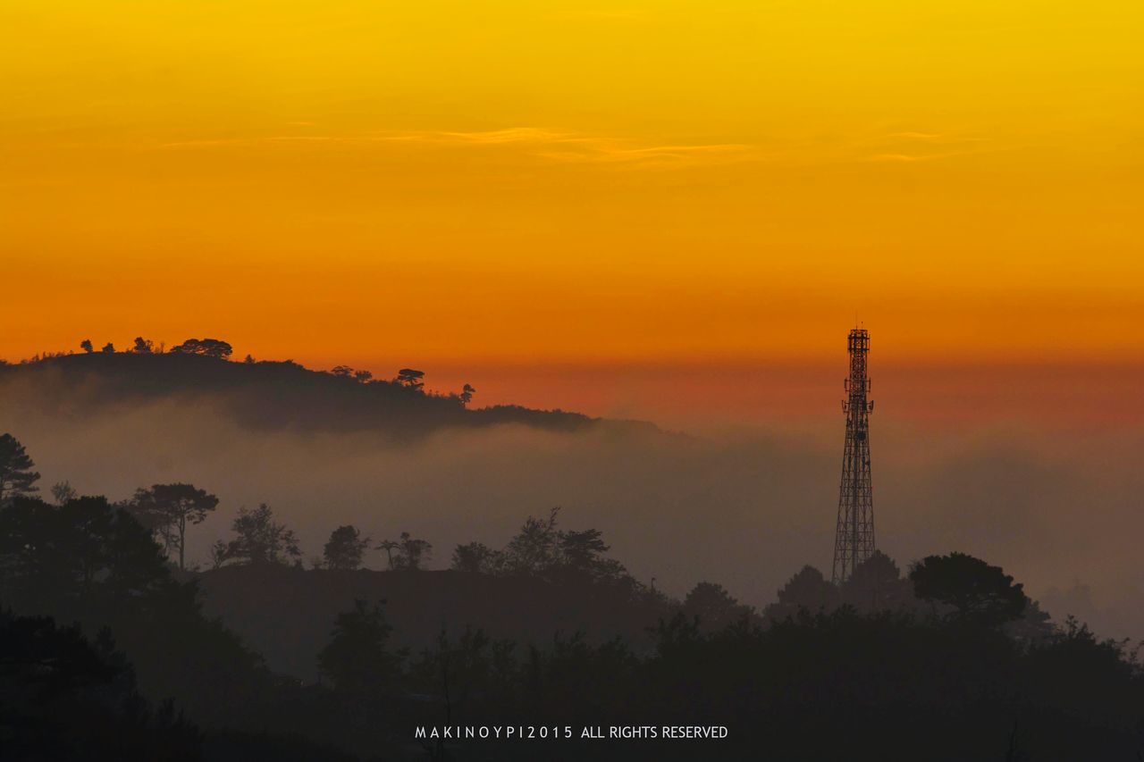 sunset, orange color, silhouette, sky, beauty in nature, scenics, nature, tranquility, tranquil scene, idyllic, tree, dusk, cloud - sky, outdoors, no people, built structure, mountain, low angle view, copy space, landscape