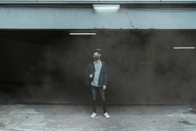 Full length of man standing in smoke