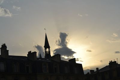 Low angle view of buildings against sky at sunset