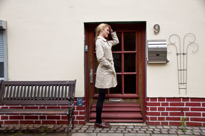 Woman standing against wall