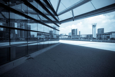 Modern buildings against sky seen through glass window