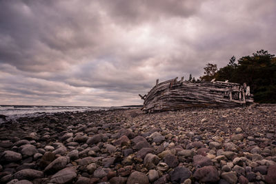Pebbles on beach against sky