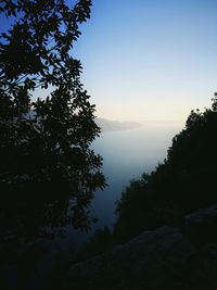 Scenic view of silhouette mountain against sky at sunset