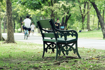 Crowd of people exercising, running and riding bicycle in the park on a beautiful sunday morning