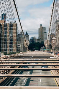 Bridge in city against sky