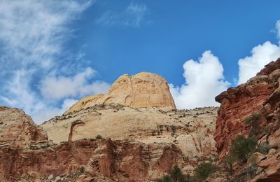 Low angle view of rock formations against sky