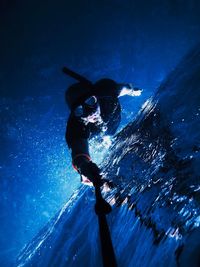 Low angle view of man swimming in sea