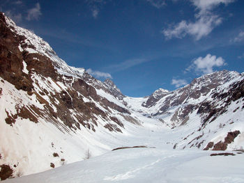 Scenic view of snow covered mountains against sky