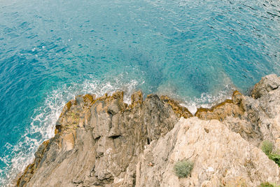 High angle view of rocks in sea