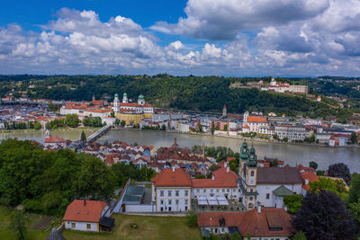 High angle view of townscape by river against sky