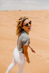 Young woman wearing sunglasses on beach