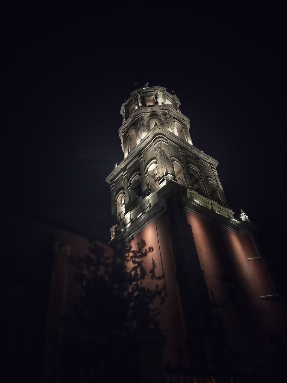 darkness, night, architecture, low angle view, light, built structure, building exterior, no people, history, the past, travel destinations, building, sky, tower, religion, place of worship, nature, city, lighting, illuminated, belief, copy space, reflection, spirituality, outdoors