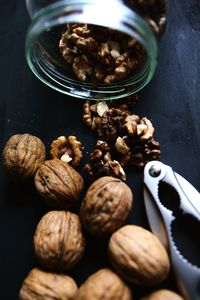 Close-up of walnuts and nutcracker on table