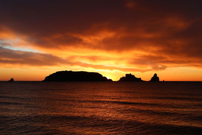 Scenic view of sea against romantic sky at sunset